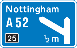UK motorway sign for a junction ahead, showing the route number and destination for the exit
