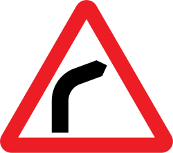 UK bend to the right warning sign: a red-bordered triangle with a black arrow curving to the right