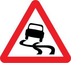 UK slippery road warning sign: a red-bordered triangle with a black car and wavy skid marks