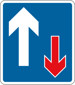 UK sign showing traffic has priority over oncoming vehicles: a blue rectangle with a white arrow pointing up and a red arrow pointing down