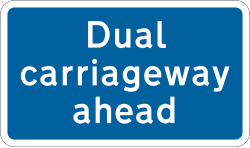 UK dual carriageway ahead information sign on a blue rectangle