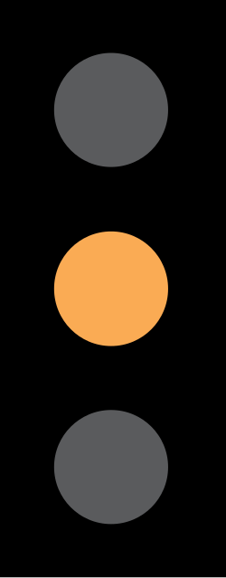 UK traffic signal showing a single amber light
