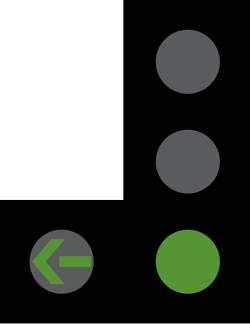 UK traffic signal showing a green light with a green filter arrow pointing left