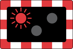 UK level crossing style signal with an amber light above two red lights, one red light lit because the pair flash alternately